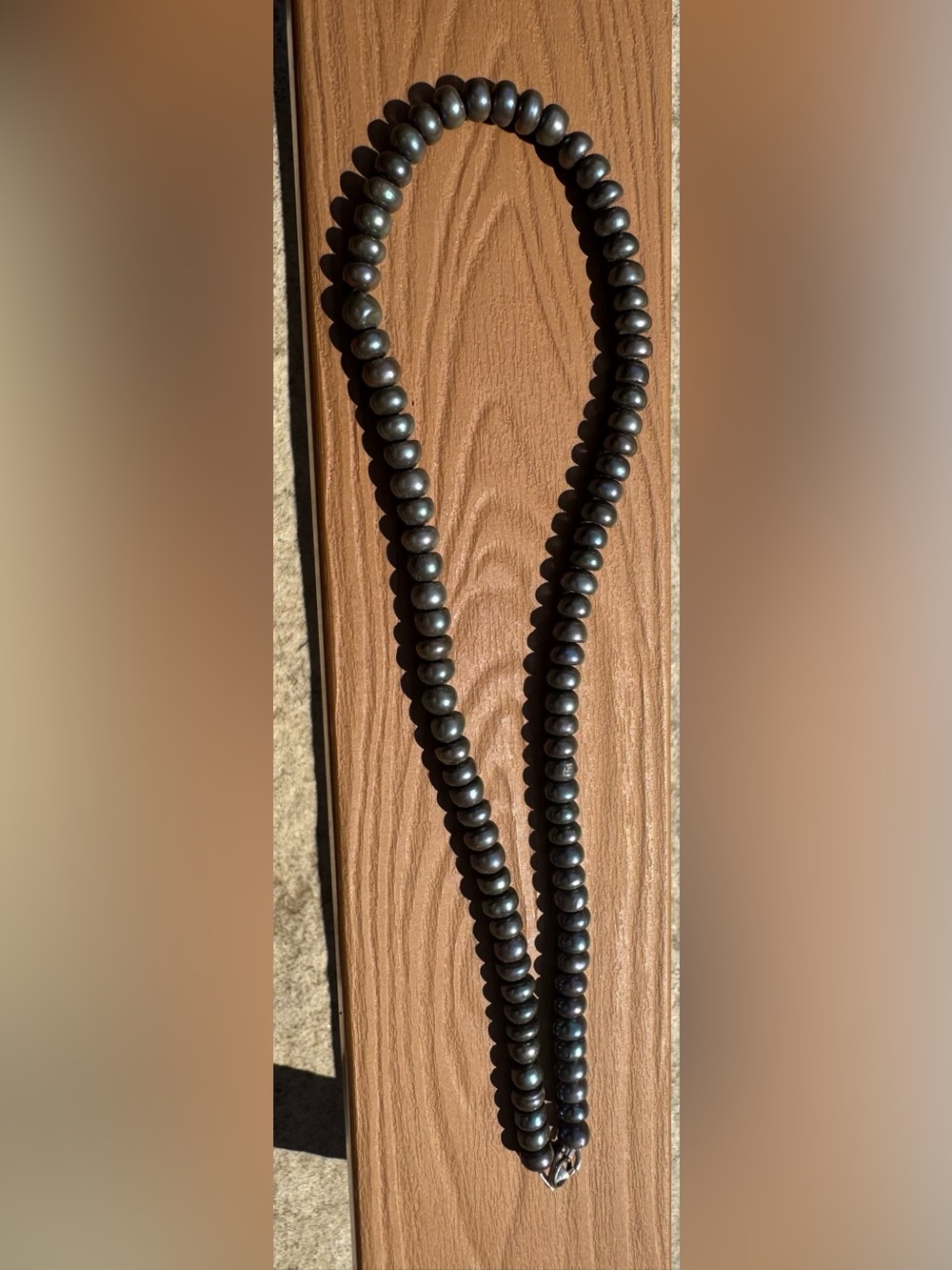 Beautiful cultured peacock color button pearls. Sterling silver clasp.